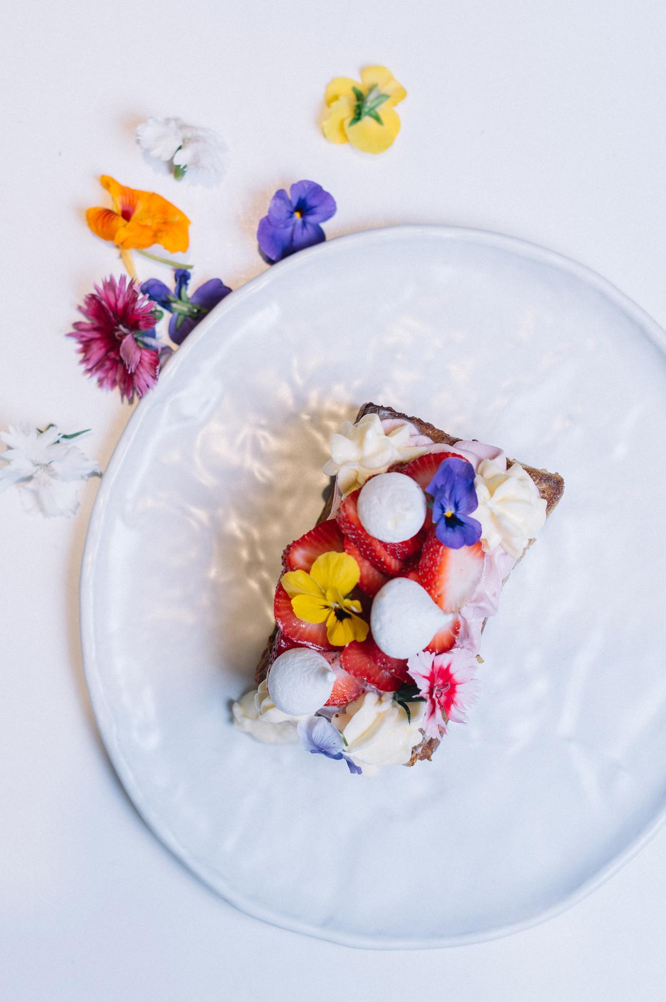 minimal dessert with edible flowers and glaze